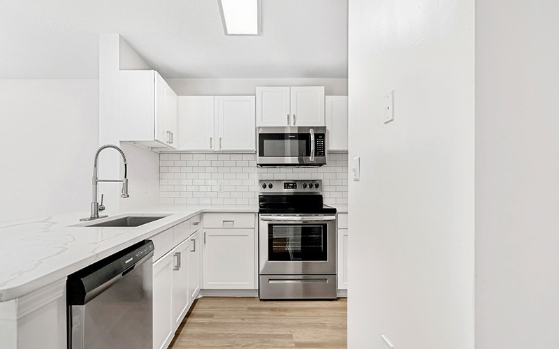 kitchen with white cupboards and stainless steel appliances