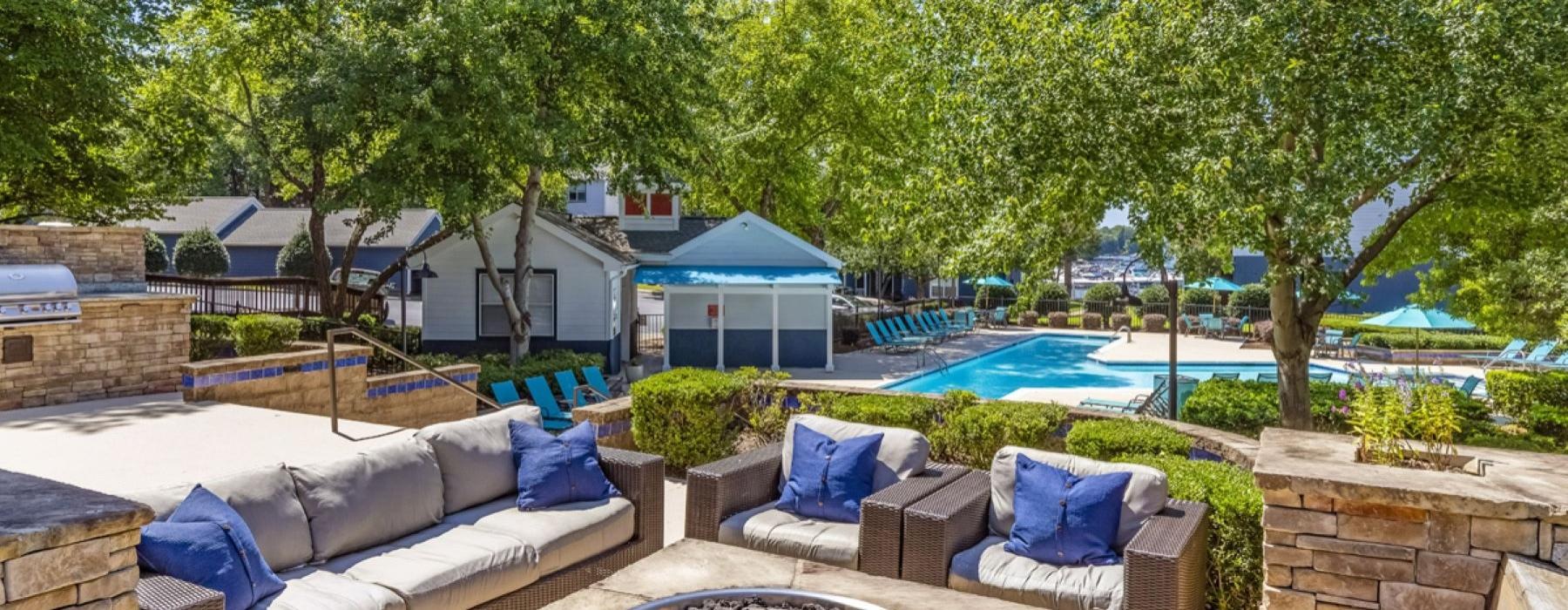 a courtyard with a pool and a fire pit